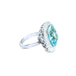 18ct white gold aquamarine and diamond ring featuring a 15.77ct cushion cut aquamarine surrounded by a cushion-shaped diamond halo.