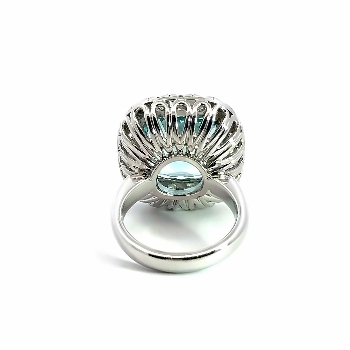 18ct white gold aquamarine and diamond ring featuring a 15.77ct cushion cut aquamarine surrounded by a cushion-shaped diamond halo.