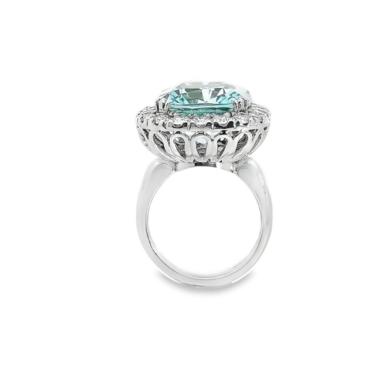 18ct white gold aquamarine and diamond ring featuring a 15.77ct cushion cut aquamarine surrounded by a cushion-shaped diamond halo.