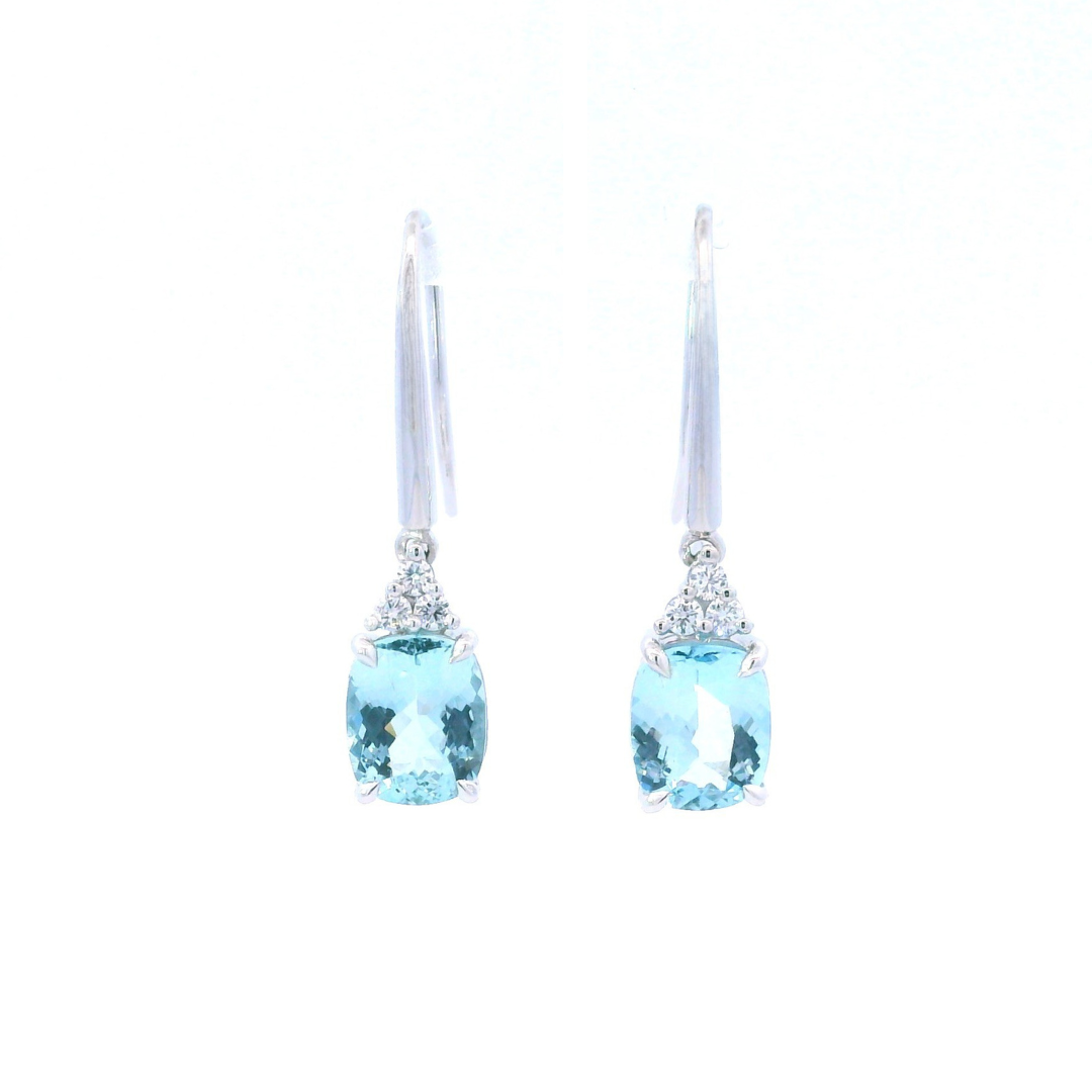18ct white gold aquamarine and diamond drop earrings featuring cushion cut aquamarines suspended from triangular diamond clusters with articulated hook fittings.