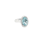 18ct white gold aquamarine and diamond halo ring featuring a 5.38ct oval aquamarine with 24 round brilliant cut diamonds, size N (resizeable).