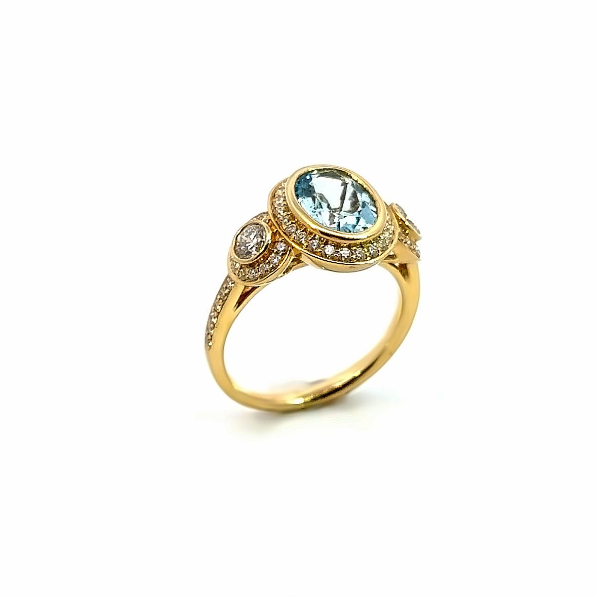 18ct yellow gold aquamarine and diamond ring featuring a 1.68ct oval aquamarine in a diamond halo bezel with side halos and bead-set diamond shoulders.