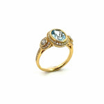 18ct yellow gold aquamarine and diamond ring featuring a 1.68ct oval aquamarine in a diamond halo bezel with side halos and bead-set diamond shoulders.