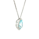 18ct white gold pendant featuring a 3.14ct pear-cut aquamarine in a three-claw setting with a graduated diamond halo surround and concealed pendant runner.