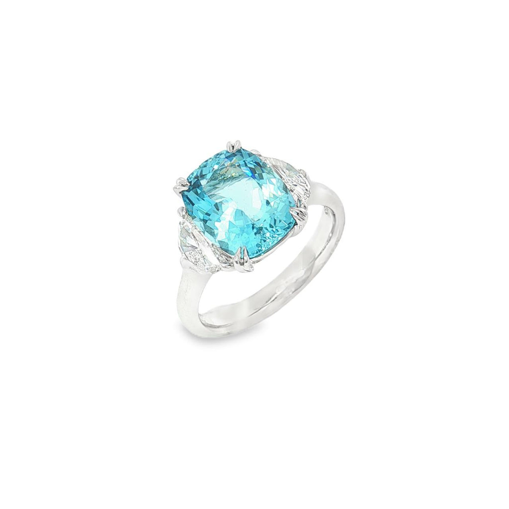 18ct white gold three-stone ring featuring a 3.44ct cushion cut aquamarine with two half moon cut diamond side stones.