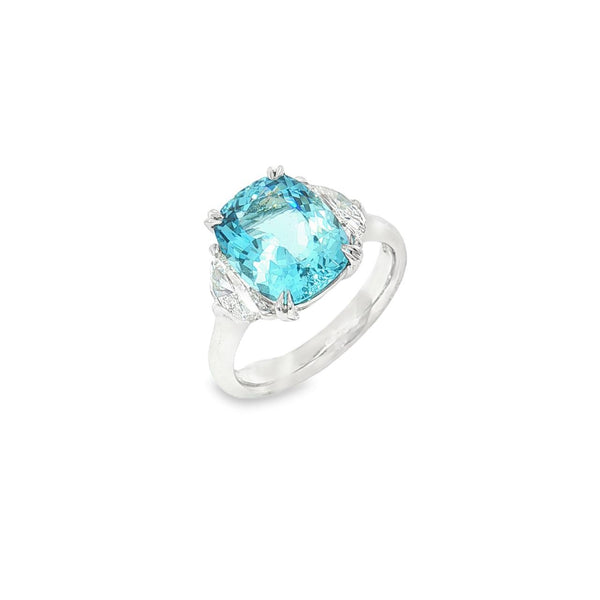 18ct white gold three-stone ring featuring a 3.44ct cushion cut aquamarine with two half moon cut diamond side stones.
