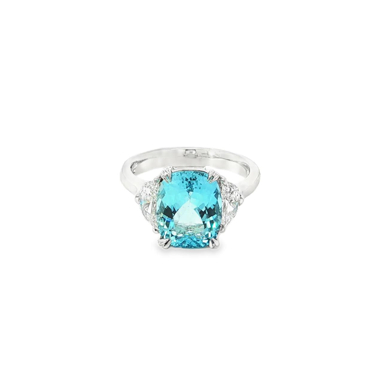 18ct white gold three-stone ring featuring a 3.44ct cushion cut aquamarine with two half moon cut diamond side stones.