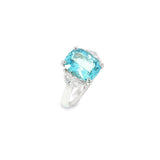 18ct white gold three-stone ring featuring a 3.44ct cushion cut aquamarine with two half moon cut diamond side stones.