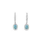 18ct white gold aquamarine and diamond drop earrings with oval blue gemstones and diamond halo