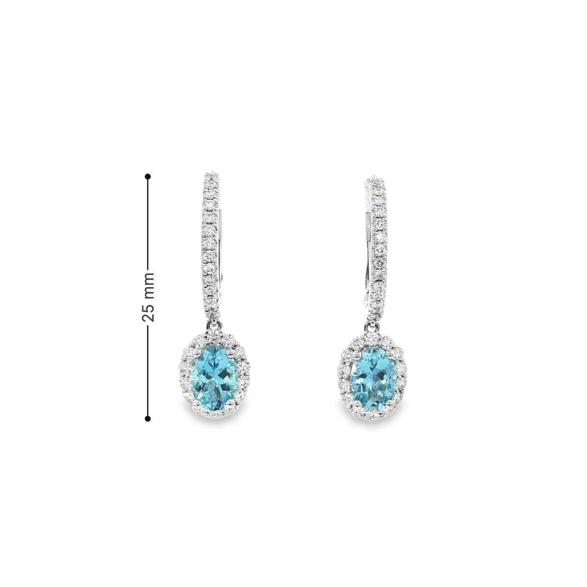 18ct white gold aquamarine and diamond drop earrings with oval blue gemstones and diamond halo