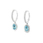18ct white gold aquamarine and diamond drop earrings with oval blue gemstones and diamond halo