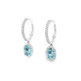 18ct white gold aquamarine and diamond drop earrings with oval blue gemstones and diamond halo