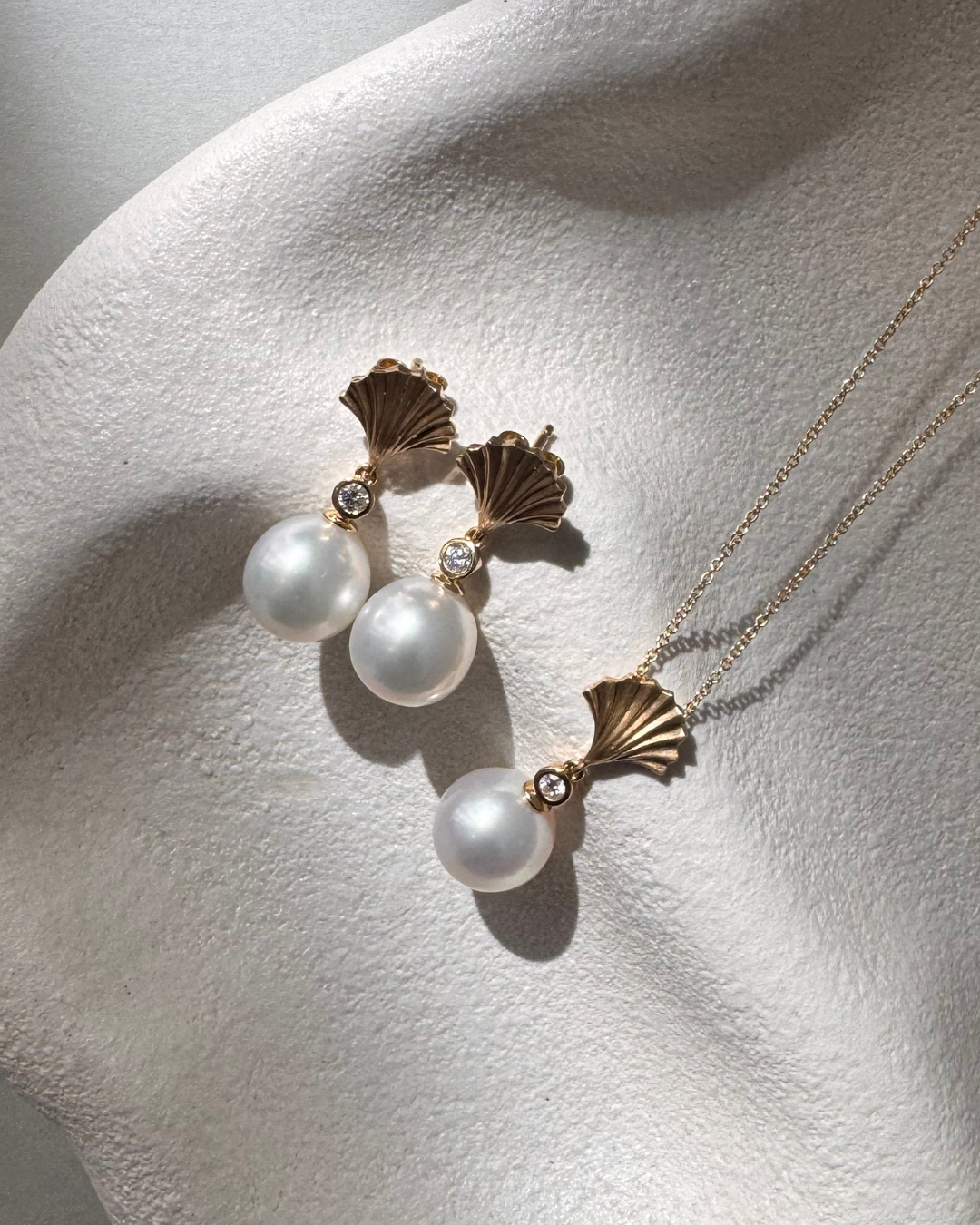 Autore 18ct yellow gold South Sea pearl and diamond earrings with fan-shaped diamond tops and articulated 10mm pearl drops.