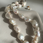 Strand of 19 freshwater baroque pearls measuring 14–18mm, individually knotted and finished with a sterling silver double oval link clasp.