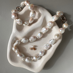 Strand of 19 freshwater baroque pearls measuring 14–18mm, individually knotted and finished with a sterling silver double oval link clasp.