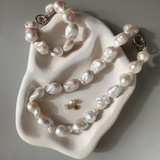 Strand of 19 freshwater baroque pearls measuring 14–18mm, individually knotted and finished with a sterling silver double oval link clasp.