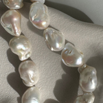 Strand of 19 freshwater baroque pearls measuring 14–18mm, individually knotted and finished with a sterling silver double oval link clasp.