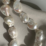 Strand of 19 freshwater baroque pearls measuring 14–18mm, individually knotted and finished with a sterling silver double oval link clasp.