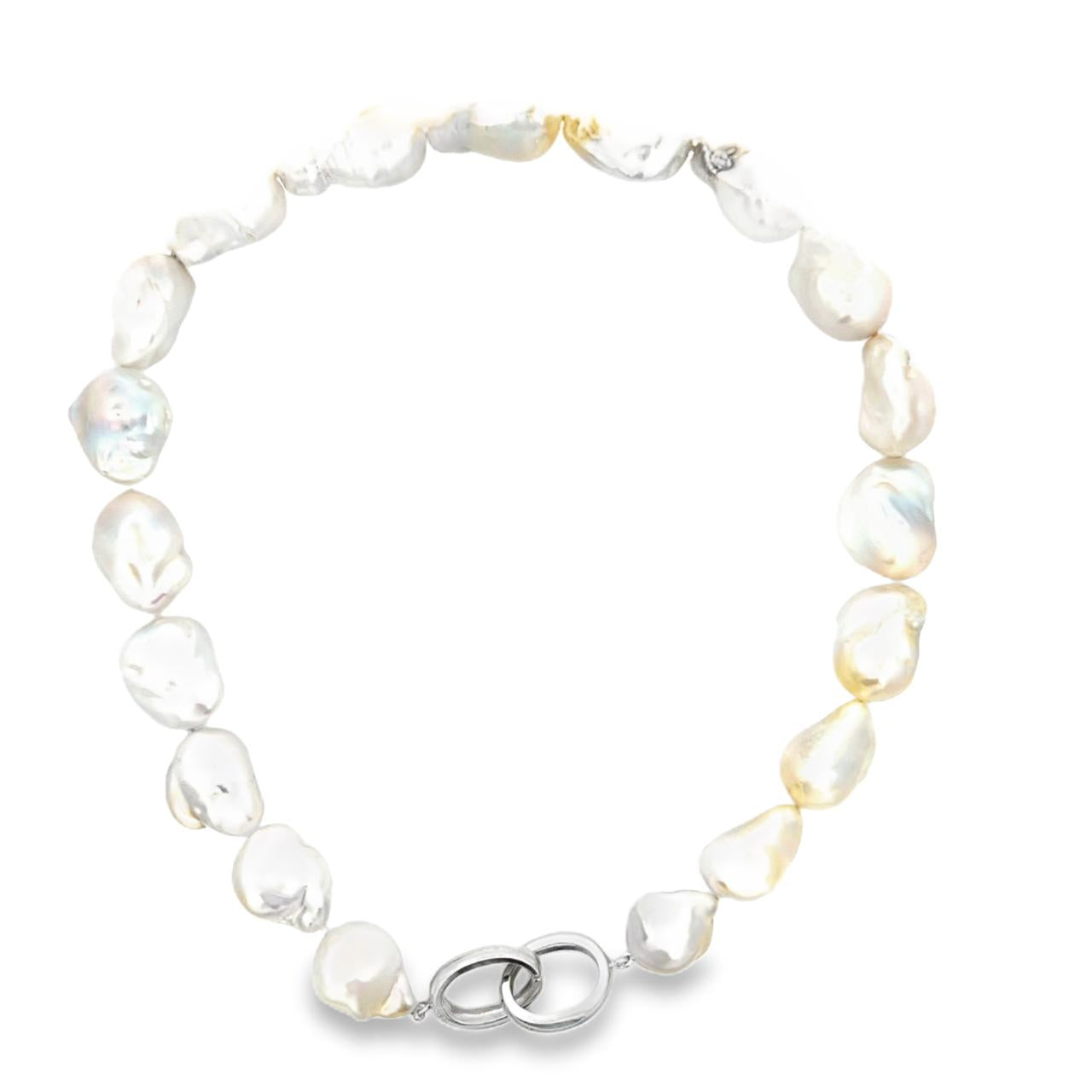Strand of 19 freshwater baroque pearls measuring 14–18mm, individually knotted and finished with a sterling silver double oval link clasp.
