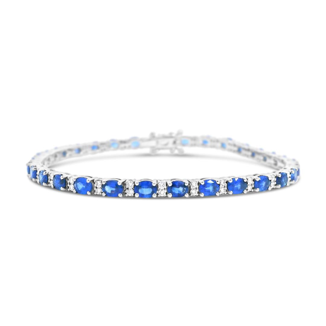 18ct white gold bracelet featuring 31 oval blue sapphires and 62 round brilliant cut diamonds with a box clasp and double figure-eight safety catches.