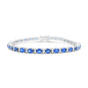 18ct white gold bracelet featuring 31 oval blue sapphires and 62 round brilliant cut diamonds with a box clasp and double figure-eight safety catches.