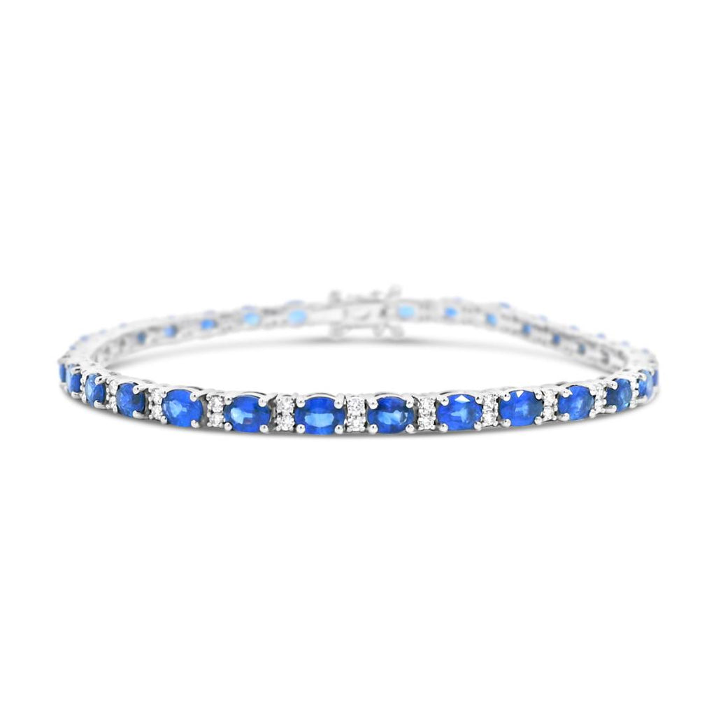18ct white gold bracelet featuring 31 oval blue sapphires and 62 round brilliant cut diamonds with a box clasp and double figure-eight safety catches.