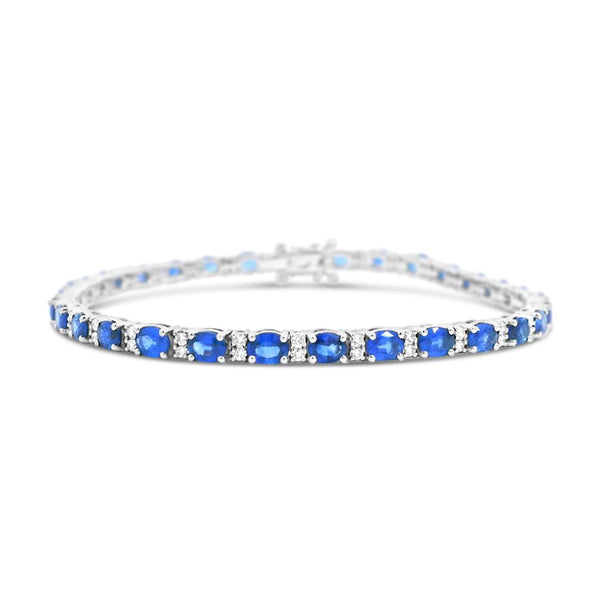 18ct white gold bracelet featuring 31 oval blue sapphires and 62 round brilliant cut diamonds with a box clasp and double figure-eight safety catches.
