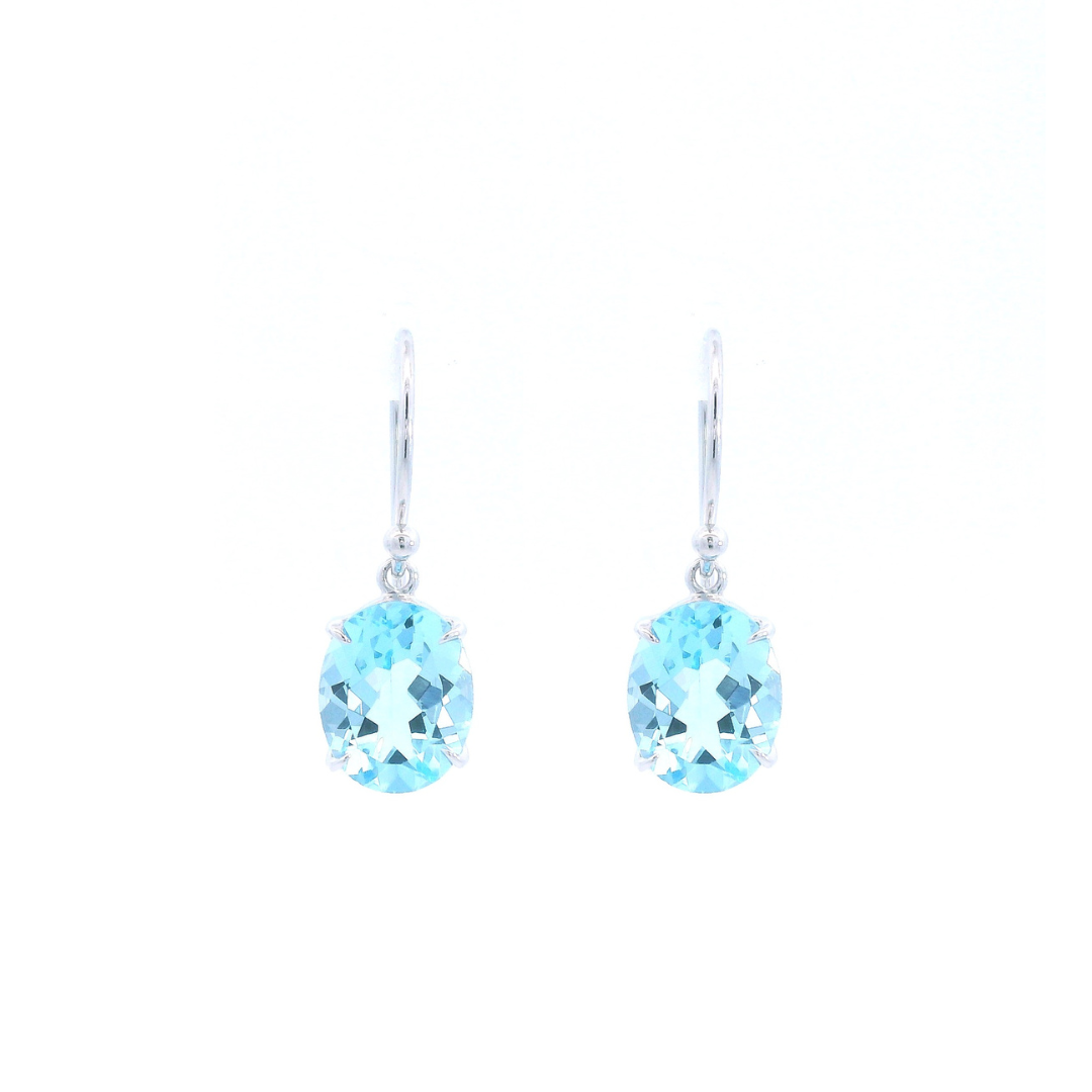 9ct white gold drop earrings featuring 10x8mm oval-cut blue topaz gemstones in four-claw settings with hook fittings.