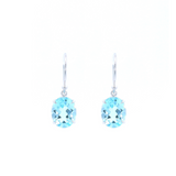 9ct white gold drop earrings featuring 10x8mm oval-cut blue topaz gemstones in four-claw settings with hook fittings.