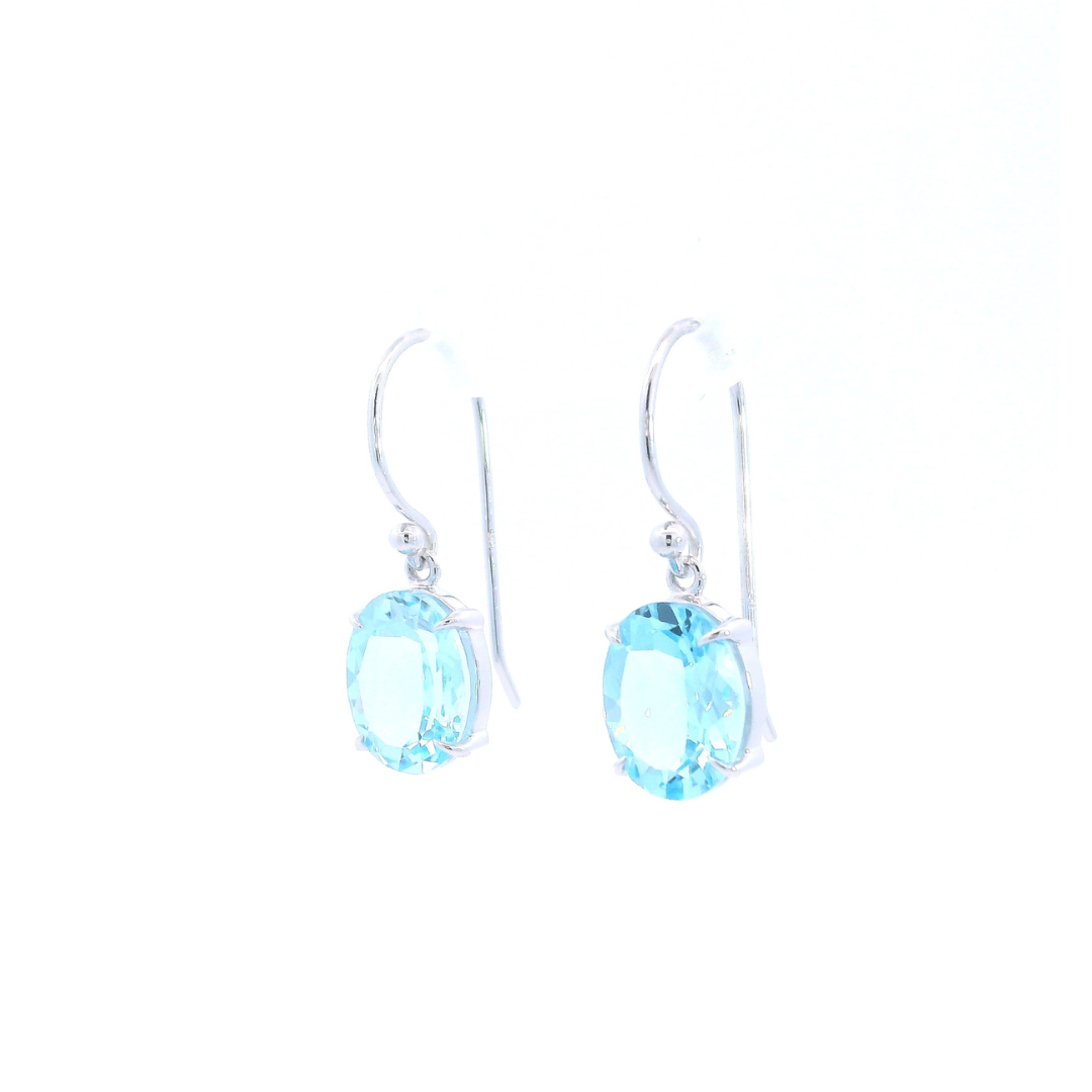 9ct white gold drop earrings featuring 10x8mm oval-cut blue topaz gemstones in four-claw settings with hook fittings.