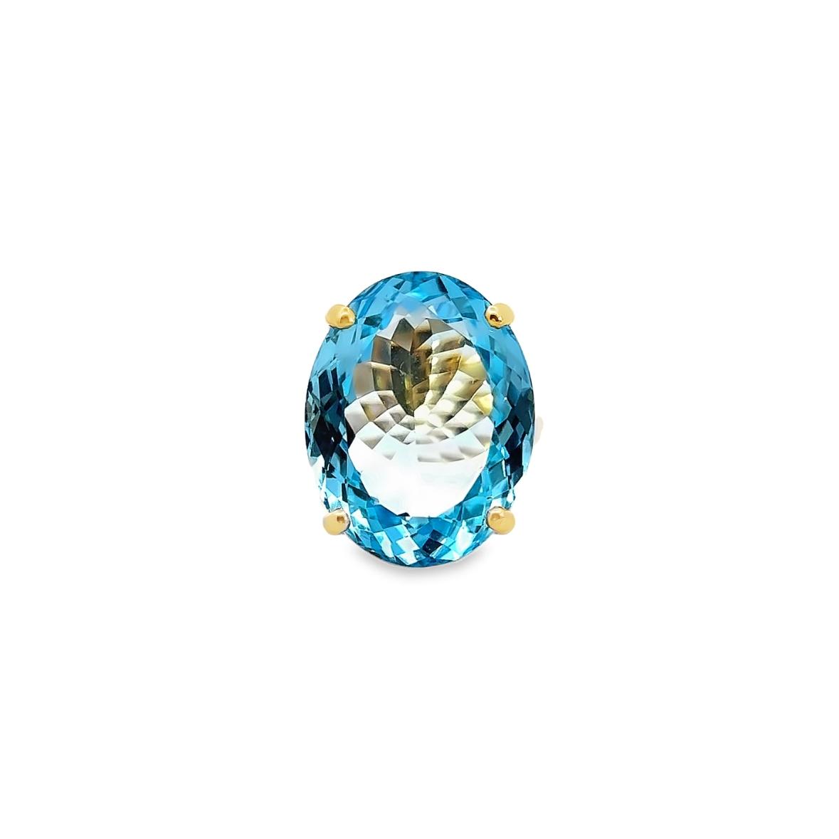 9ct yellow gold ring featuring a 23.90 x 18.60mm oval cut blue topaz in a four-claw setting with engraved shoulders.