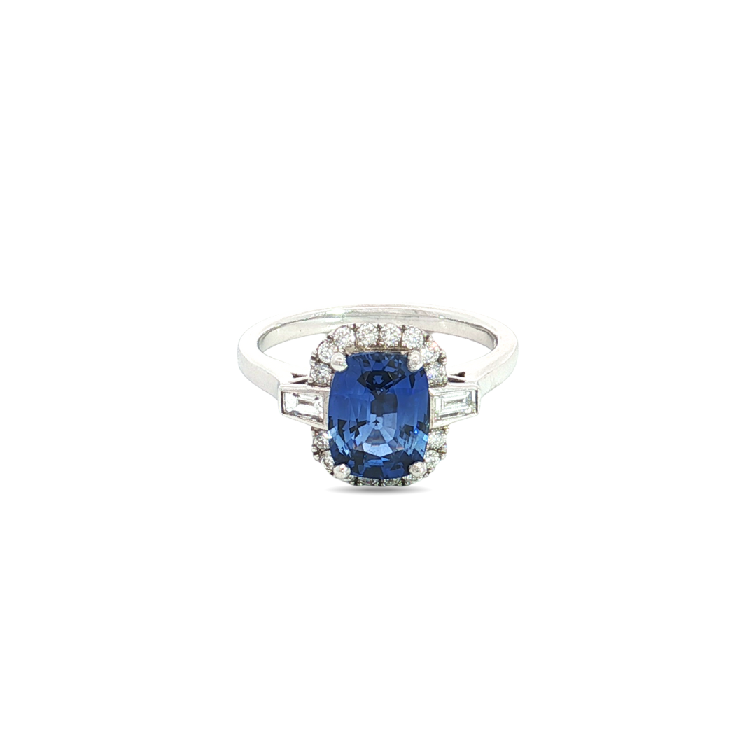 18ct white gold ring featuring a 2.21ct Ceylon sapphire flanked by tapered baguette and round brilliant cut diamonds totalling 0.50ct.