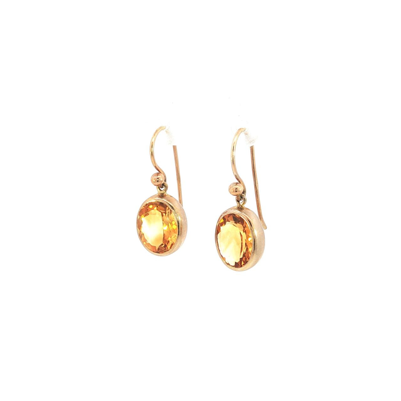 9ct yellow gold oval citrine stud earrings with bezel settings.