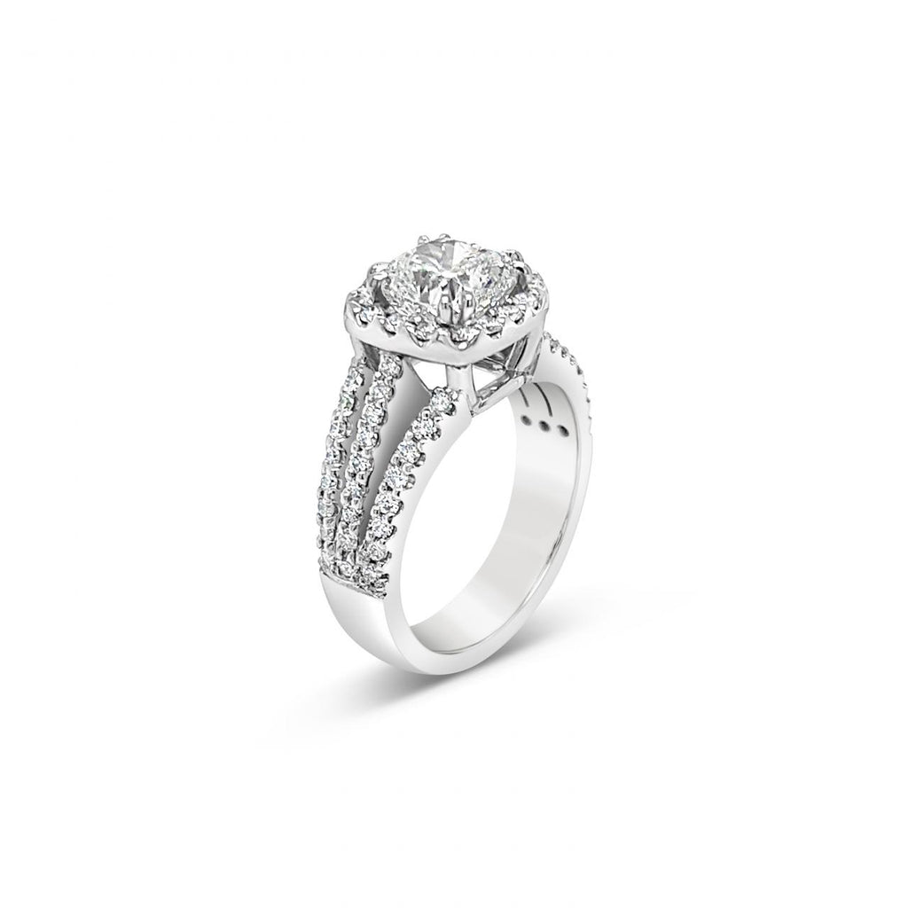 Platinum cushion cut diamond halo ring featuring a 2.00ct centre diamond with a halo surround and triple split diamond-set shoulders.