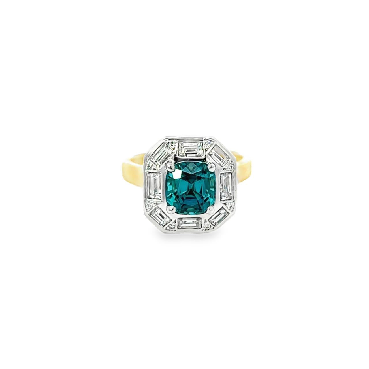 18ct yellow and white gold ring featuring a 1.88ct cushion cut greenish-blue tourmaline surrounded by baguette and round brilliant cut diamonds in an octagonal cluster design.