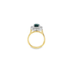 18ct yellow and white gold ring featuring a 1.88ct cushion cut greenish-blue tourmaline surrounded by baguette and round brilliant cut diamonds in an octagonal cluster design.