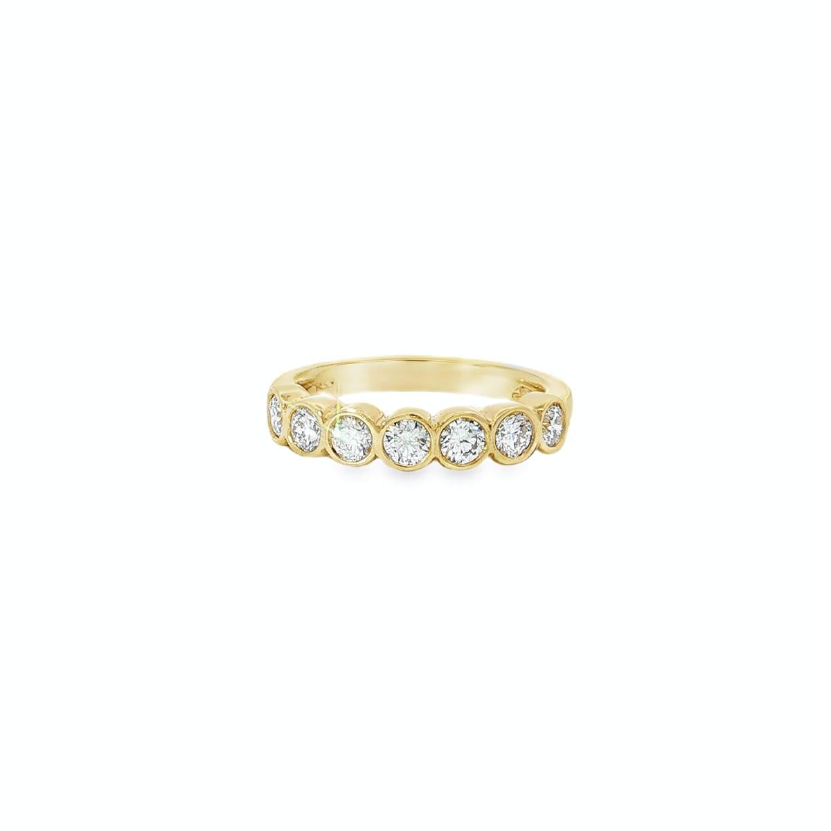 18ct yellow gold diamond ring with seven bezel set diamonds across the top