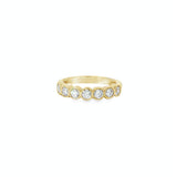 18ct yellow gold diamond ring with seven bezel set diamonds across the top