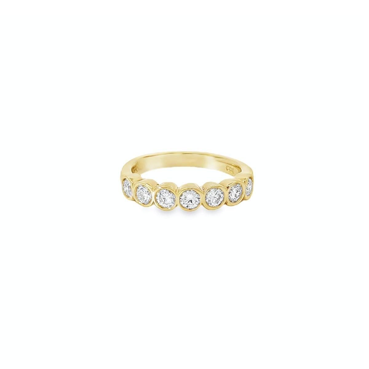18ct yellow gold diamond ring with seven bezel set diamonds across the top