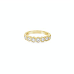 18ct yellow gold diamond ring with seven bezel set diamonds across the top