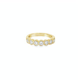18ct yellow gold diamond ring with seven bezel set diamonds across the top