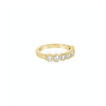 18ct yellow gold diamond ring with seven bezel set diamonds across the top