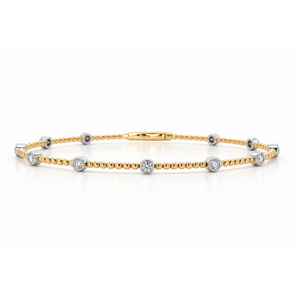 18ct yellow gold beaded bangle featuring eleven round brilliant cut diamonds in contrasting white gold bezel settings, totalling 0.38ct.