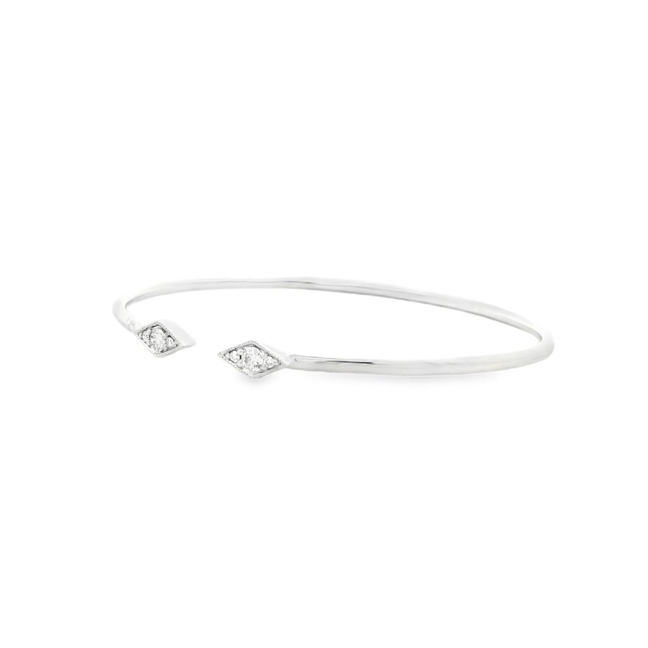 18ct white gold diamond bangle with oval profile and open gap at the top, featuring two rhombus-shaped cluster sections set with 6 round brilliant cut diamonds and millgrain edging.