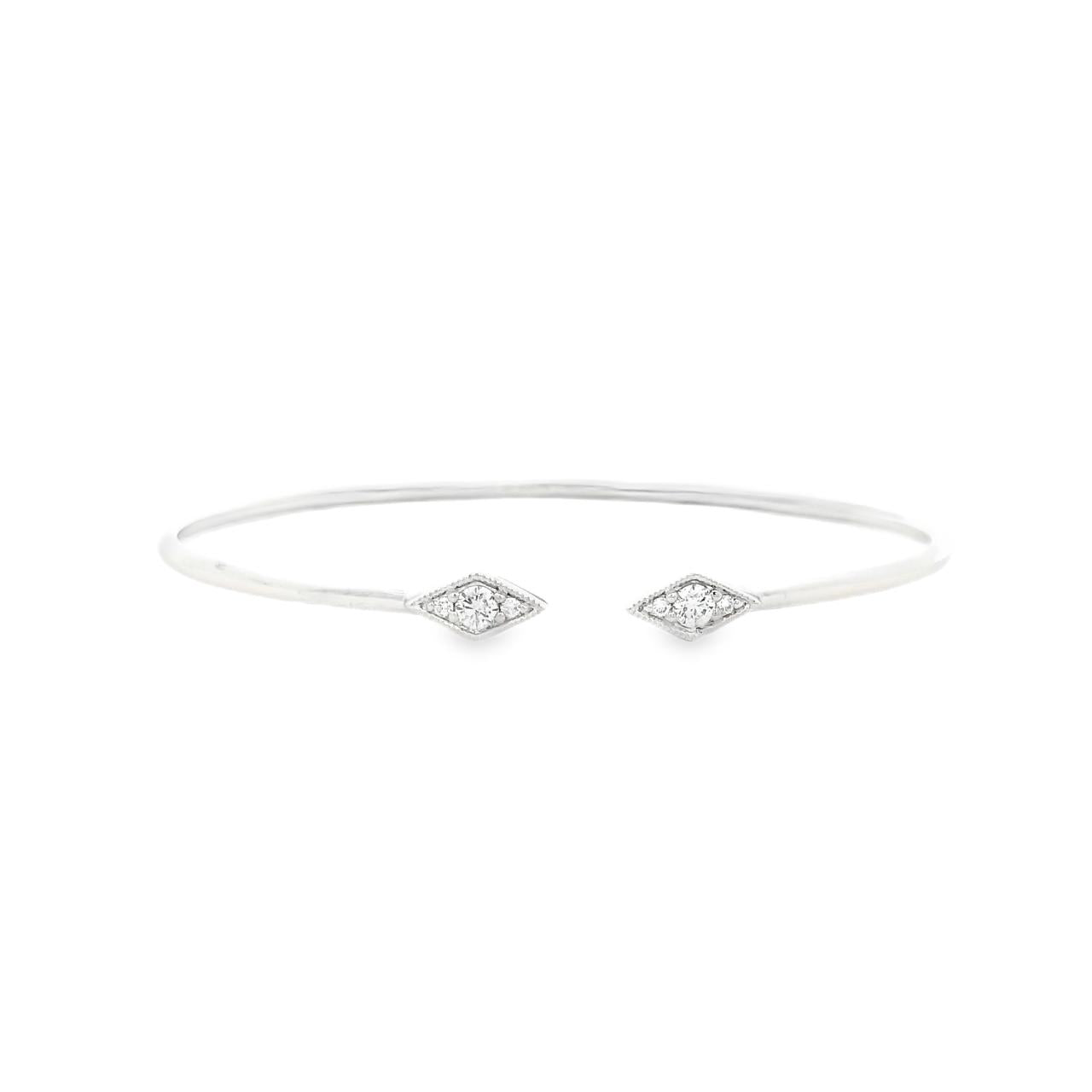 18ct white gold diamond bangle with oval profile and open gap at the top, featuring two rhombus-shaped cluster sections set with 6 round brilliant cut diamonds and millgrain edging.