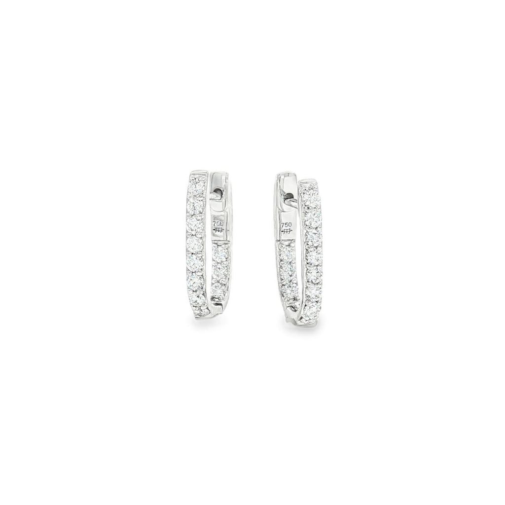 18ct white gold diamond huggie earrings featuring a hinged “U”-shape design with claw-set diamonds along the front and inside back.