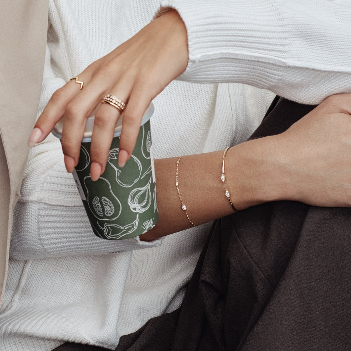 18ct yellow gold diamond bracelet with fine trace link chain, central circular mini disc bead set with diamonds, bezel-set stations along the length, and adjustable parrot clasp.