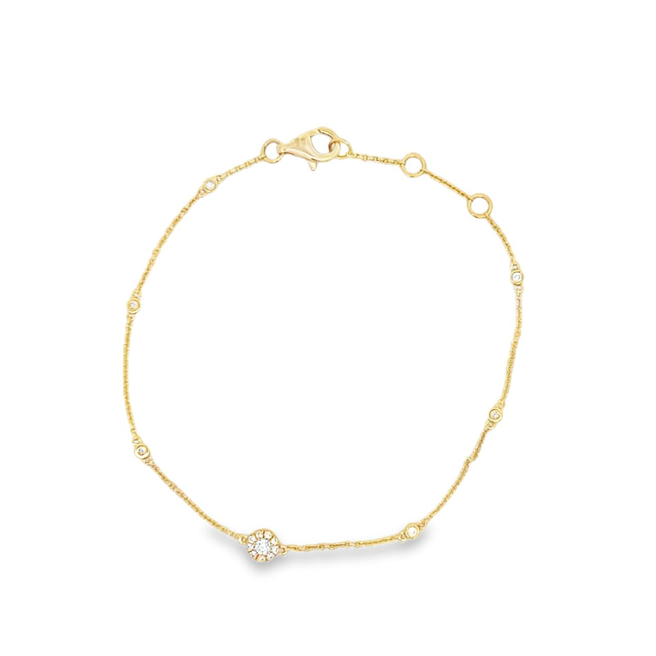 18ct yellow gold diamond bracelet with fine trace link chain, central circular mini disc bead set with diamonds, bezel-set stations along the length, and adjustable parrot clasp.