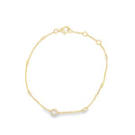 18ct yellow gold diamond bracelet with fine trace link chain, central circular mini disc bead set with diamonds, bezel-set stations along the length, and adjustable parrot clasp.