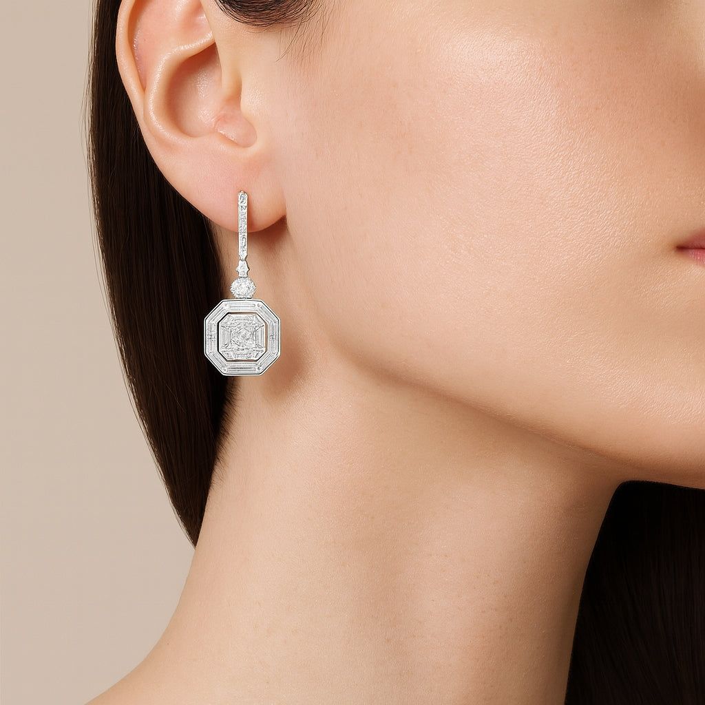 18ct white gold diamond octagonal drop earrings featuring curved bead-set bars, articulated claw-set drops, and octagonal “invisible” cluster settings with round, oval, baguette and asscher cut diamonds totalling 3.35ct G VVS–SI.